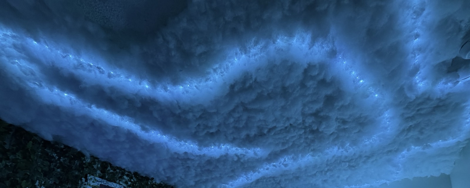 Close-up of the glowing blue cloud ceiling at Rose Garden Studios.